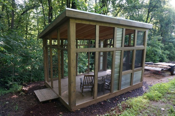 a small wooden structure with chairs in it