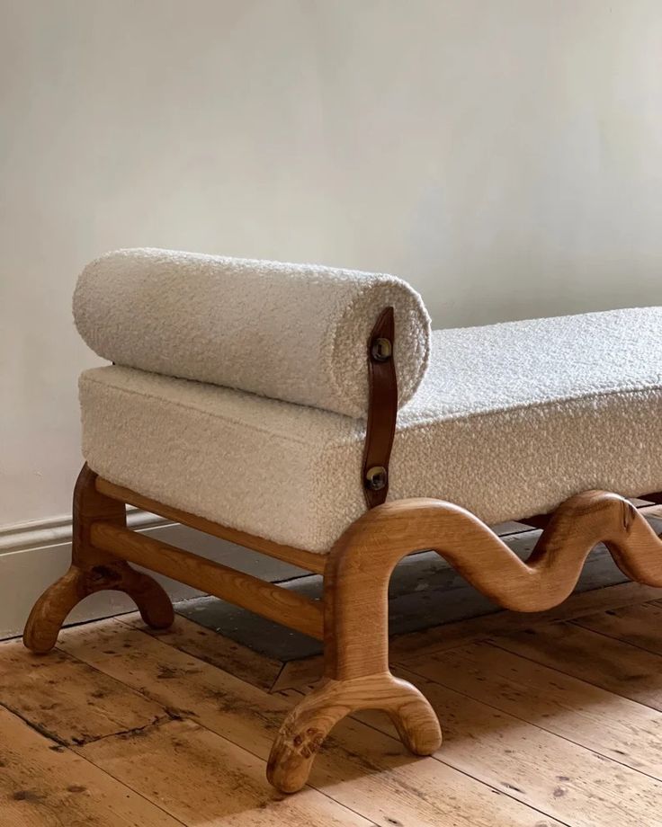 a wooden bench sitting on top of a hard wood floor