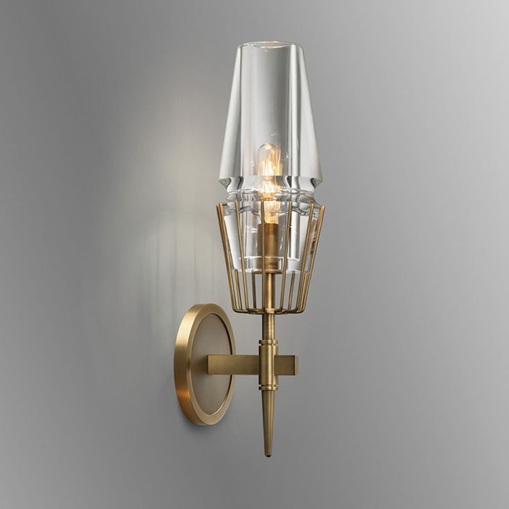 a wall light that is on the side of a wall with a glass shade over it