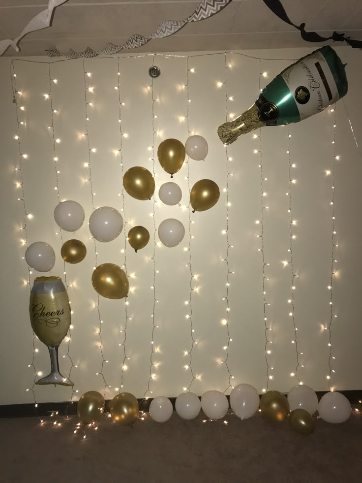 balloons and champagne are hanging on the wall