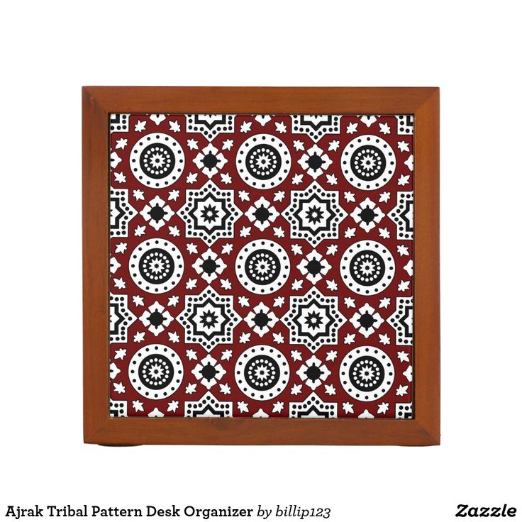 a red and black tile with white designs on it