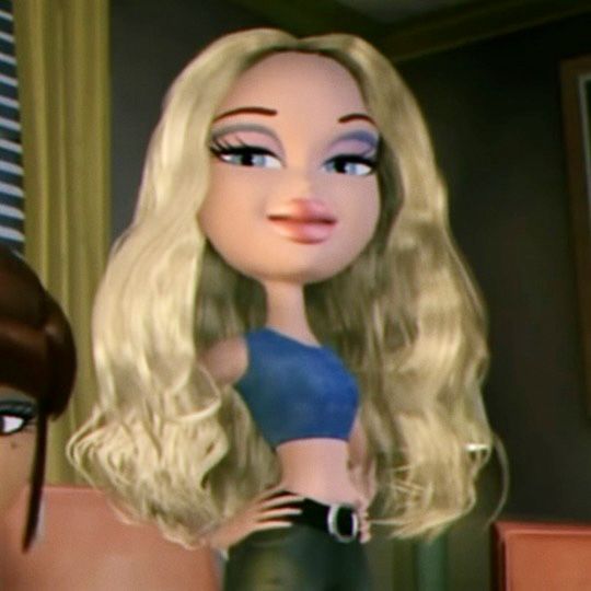 a doll with blonde hair is standing next to a woman in black pants and a blue top