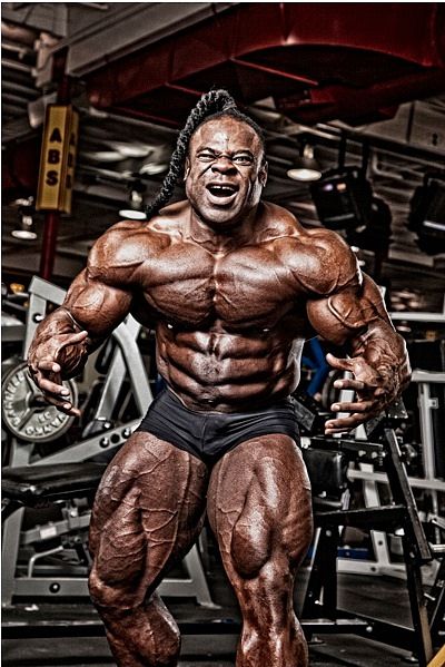 a bodybuilding man posing in the gym