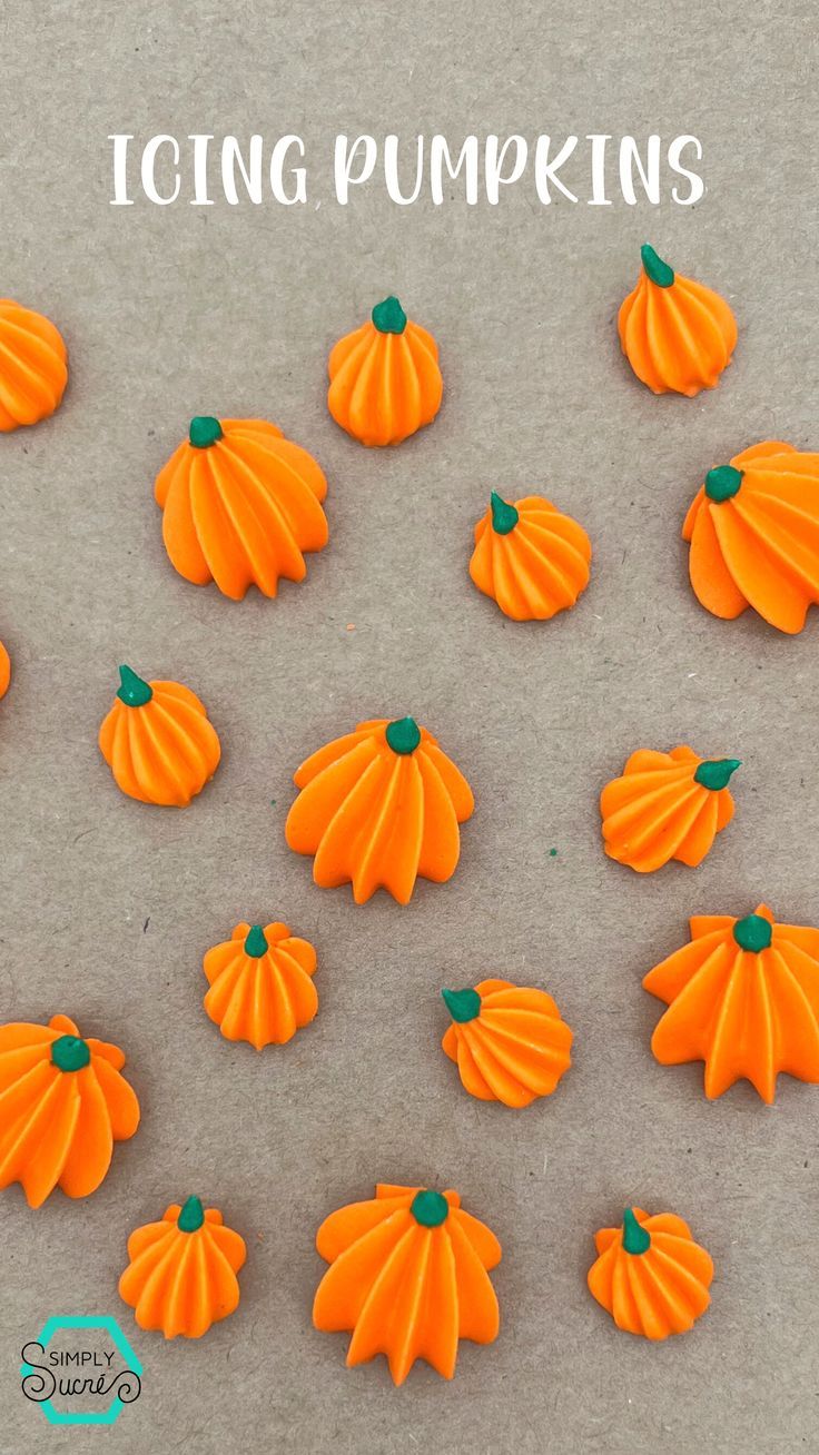 orange icing pumpkins sitting on top of a sheet of paper with the words icing pumpkins above them