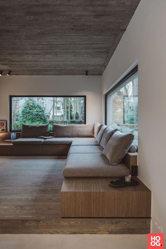 a living room filled with furniture and windows