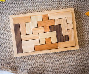 a wooden puzzle sitting on top of a table next to autumn leaves and pumpkins