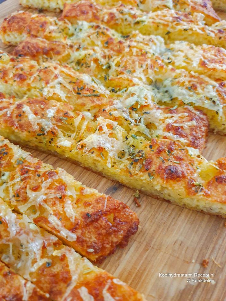 a pizza with cheese and other toppings on a cutting board