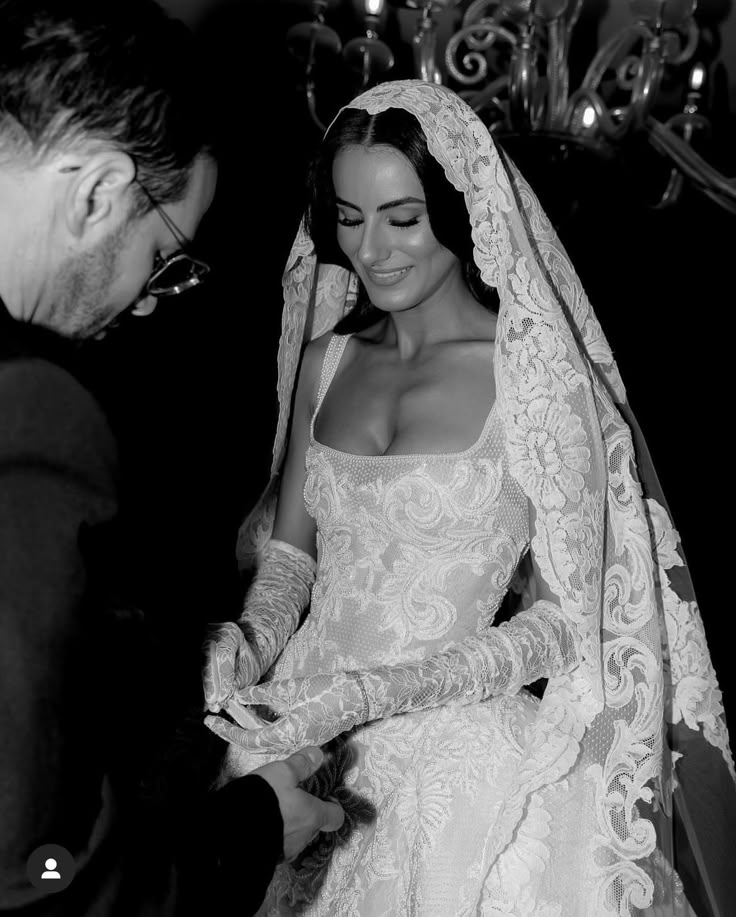 the bride is getting ready to walk down the aisle in her wedding dress and veil