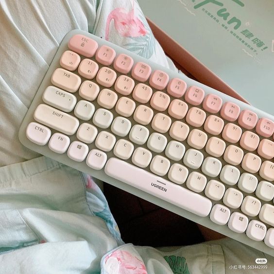 a white keyboard sitting on top of a bed