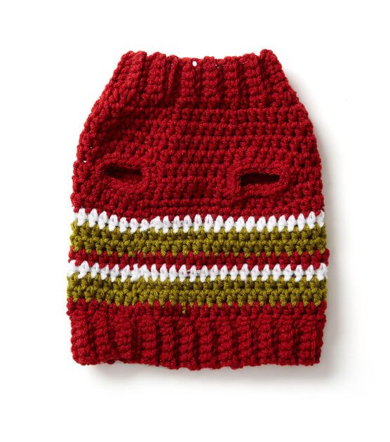 a crocheted red and green hat on a white surface