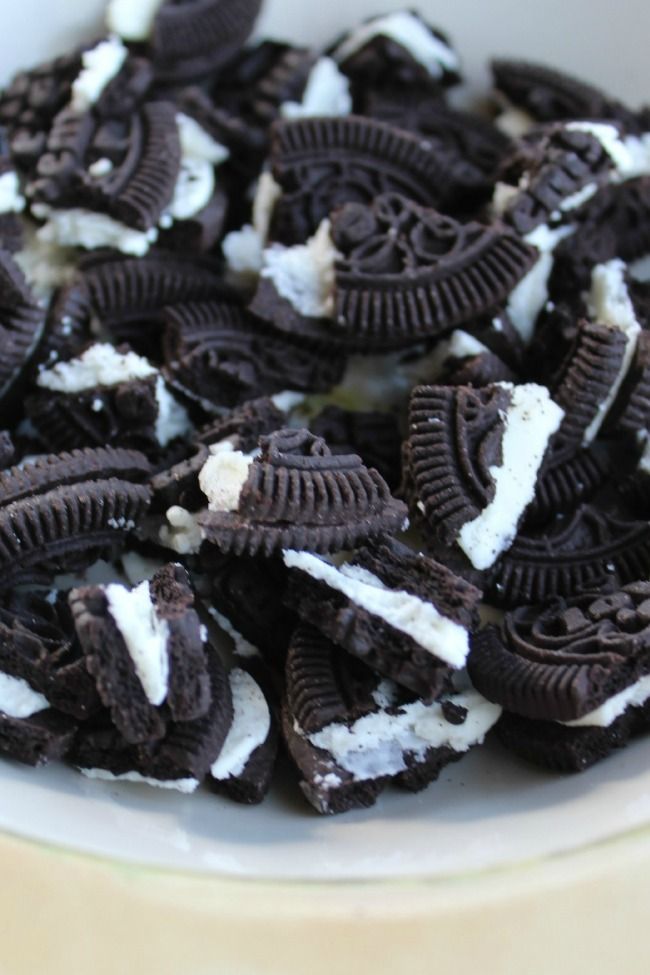 a bowl filled with oreo cookies and white cream