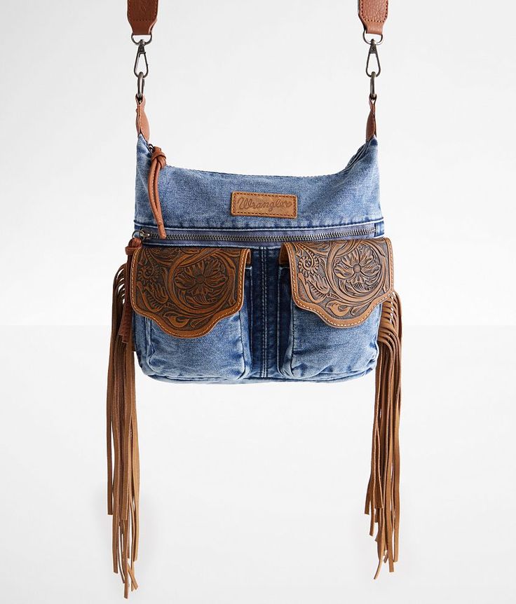 a denim purse with fringes hanging from it's front and side pockets, on a white background