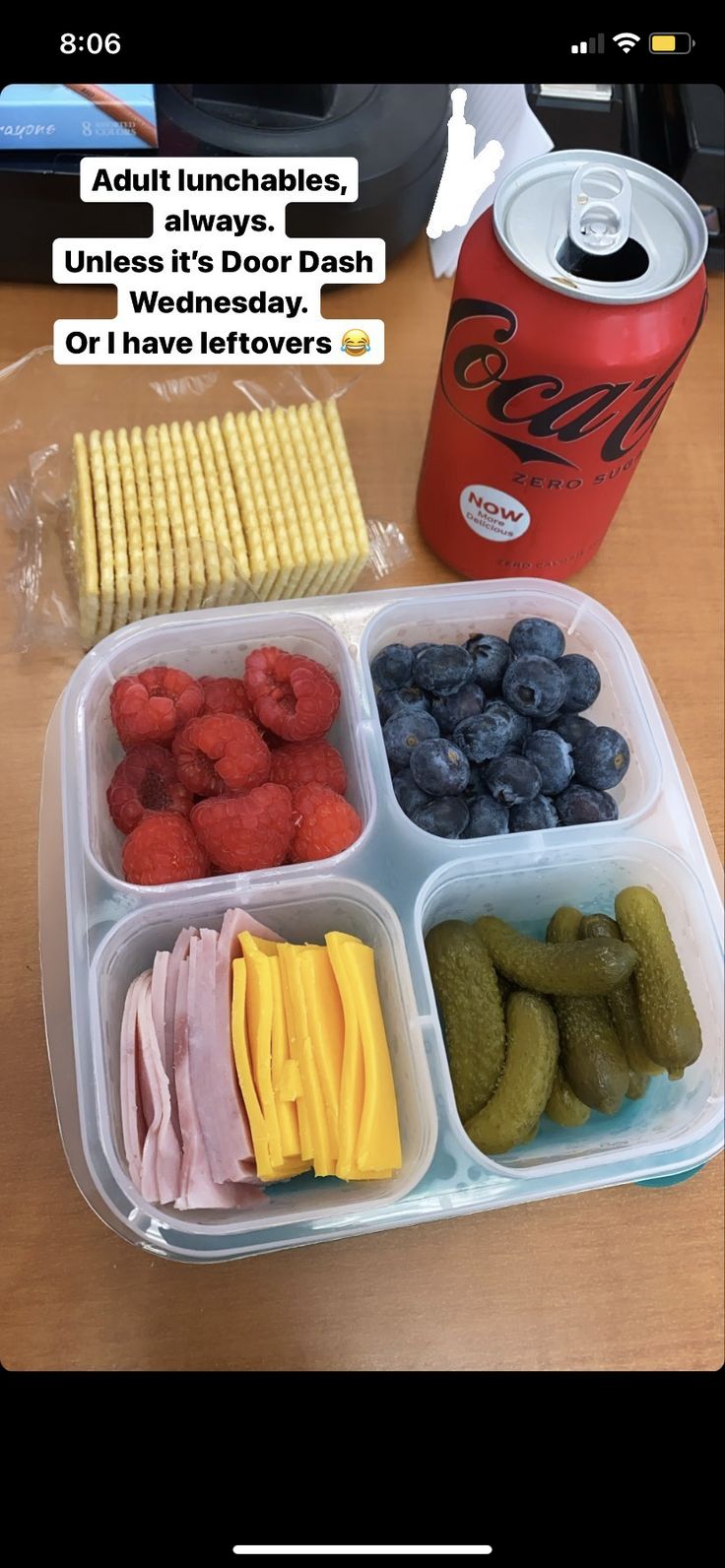 the lunch box is filled with fruit and veggies, along with a can of soda