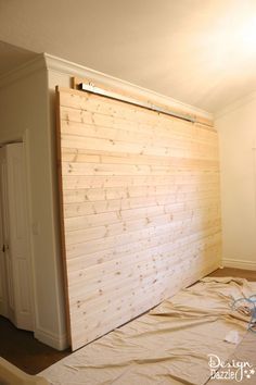 an unfinished room with white walls and wood paneling on the wall is being prepared for remodel