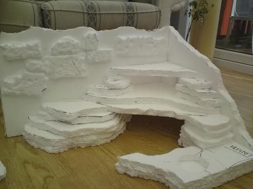 a white sculpture sitting on top of a hard wood floor next to a couch and table