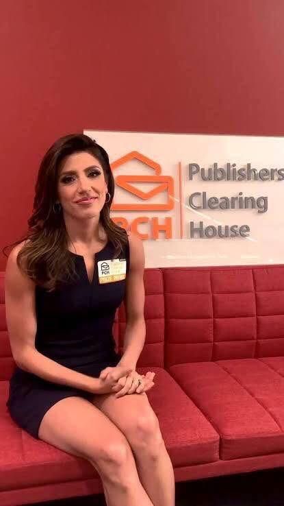 a woman sitting on top of a red couch in front of a sign that reads publishers cleaning house