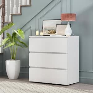 a white dresser sitting in front of a stair case next to a potted plant