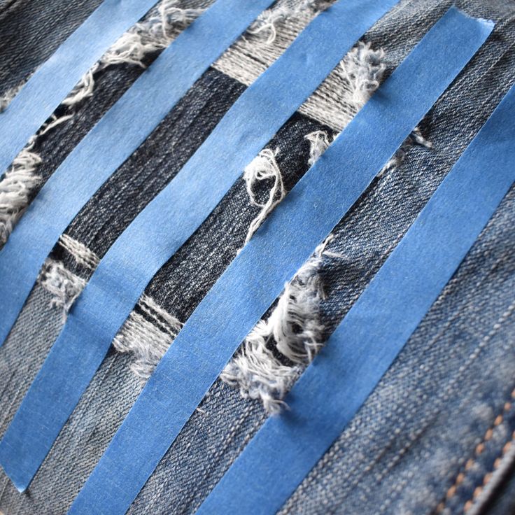 several pieces of blue jeans with holes in them