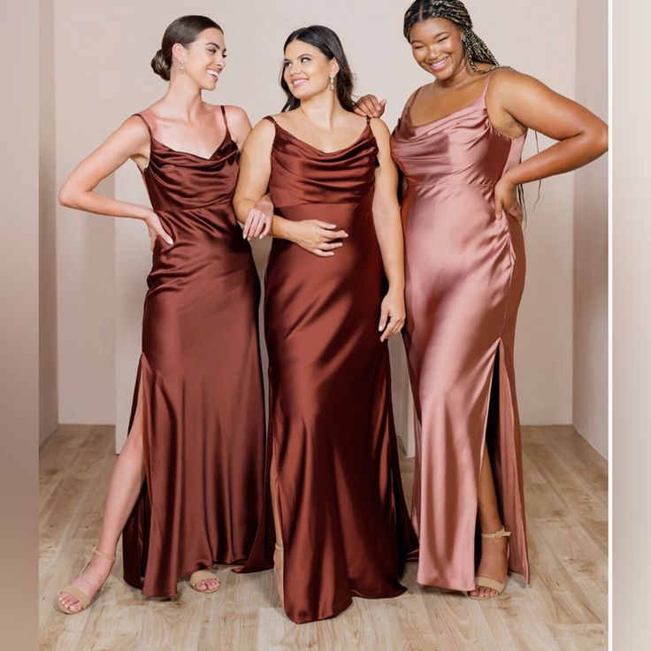 three women standing next to each other in dresses