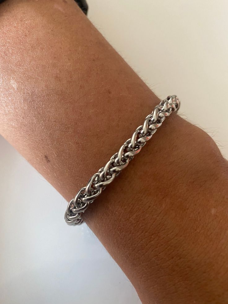 Welcome to my shop. This is a woven, braided bracelet.  This is a great bracelet for men and women. Made of Stainless Steel Clasp: Lobster Material: Stainless Steel. Size of Chain - 9x7mm  Thickness - 1.5mm If you have concerns about your skin colour and the silver colour, please agree with yourself first before buying.  All orders are customised to your size. The Model in the photo is wearing a chain length of 8 inches Please message me for any enquiries. Thank you Spiga Wheat Chain Rope Bracelet , Stainless Steel Spiga Woven Chain Bracelet, Braided Rope Chain Link Bracelet, Birthday Gift, Rope Bracelet Everyday Silver Jubilee Braided Bracelet, Everyday Stainless Steel Braided Bracelet, Silver Braided Bangle Bracelet For Everyday, Silver Braided Bracelets For Everyday, Everyday Silver Braided Bangle Bracelet, Everyday Silver Metal Braided Bracelets, Casual Braided Bracelet, Casual Braided Bracelet Jewelry, Casual Stainless Steel Braided Bracelet As Gift