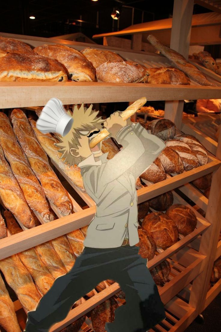 a man standing in front of a bunch of breads