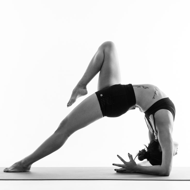 a woman is doing yoga on the floor