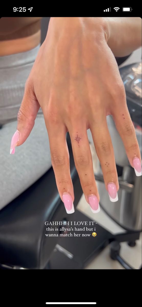 a woman's hand with pink nail polish on it