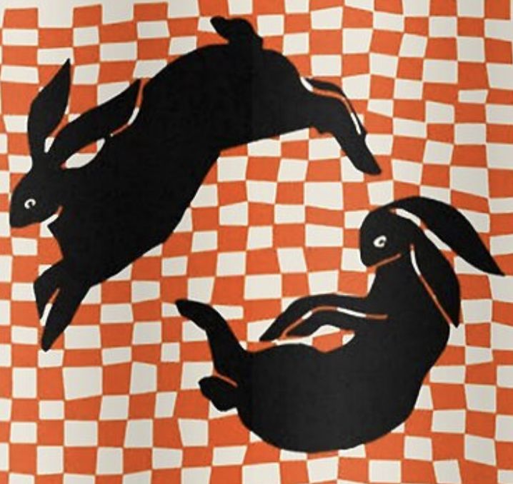 an orange and white checkered background with black silhouettes of rabbits