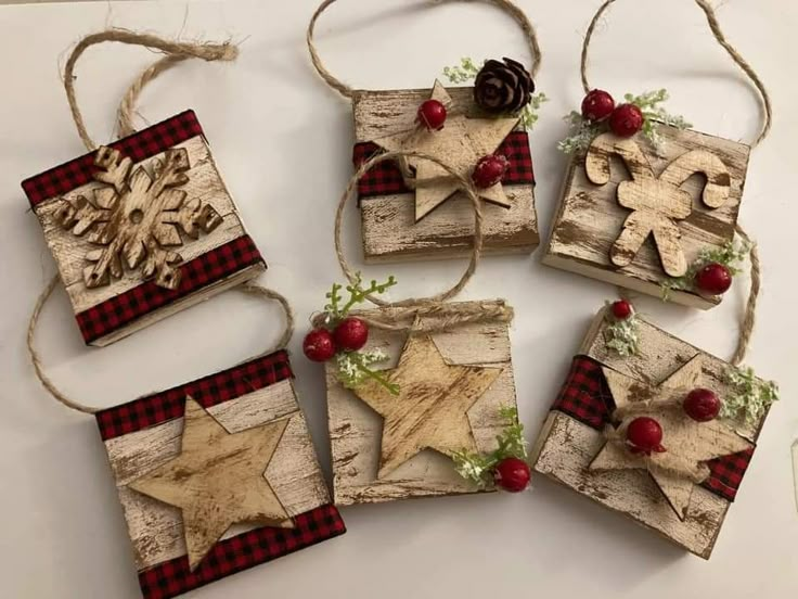 four wooden christmas ornaments hanging from twine