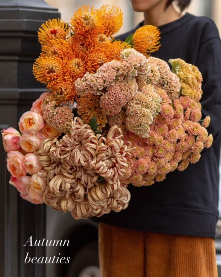 a woman is holding a bouquet of flowers