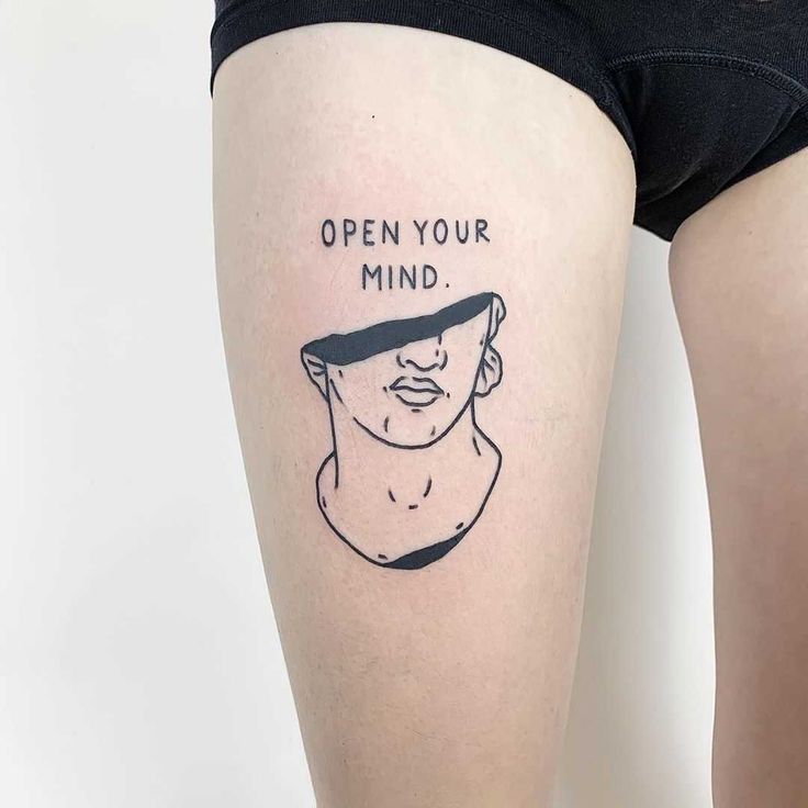 a woman's thigh with an open your mind tattoo on it