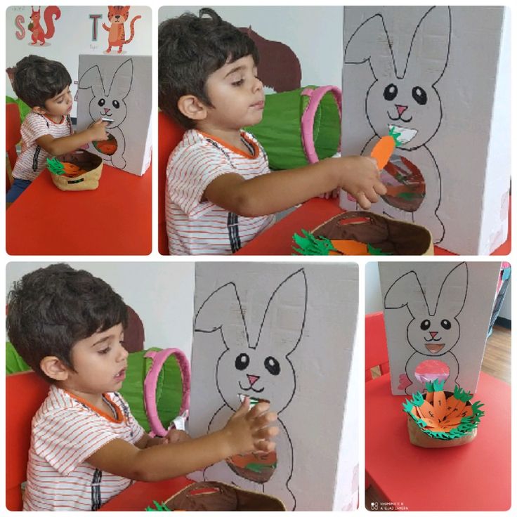 a little boy is painting a bunny with carrots in front of him and then he looks at it