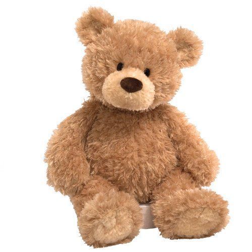 a brown teddy bear sitting up against a white background