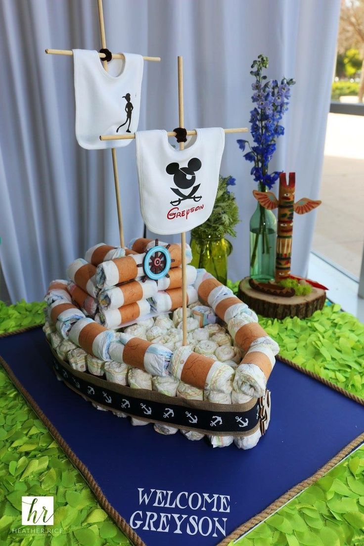 a cake made to look like a pirate ship with towels hanging from it's mast