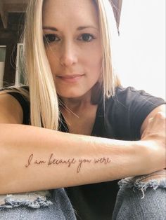 a woman with a tattoo on her arm that says i am feeling you are written in cursive font