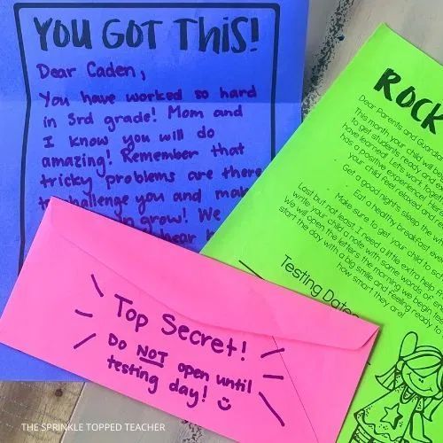 three colorful papers with writing on them and one has a note attached to the back