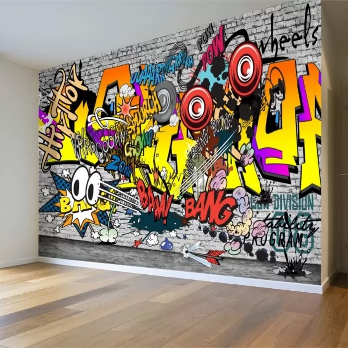 an empty room with graffiti on the wall and wood flooring in front of it