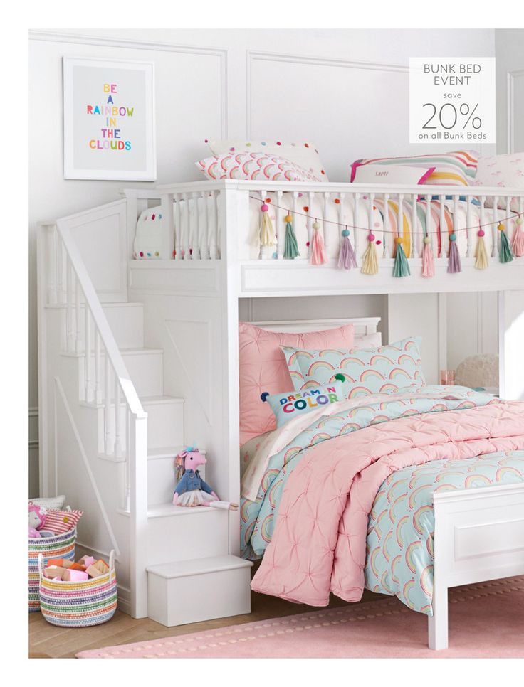 a white bunk bed with pink and blue bedspreads