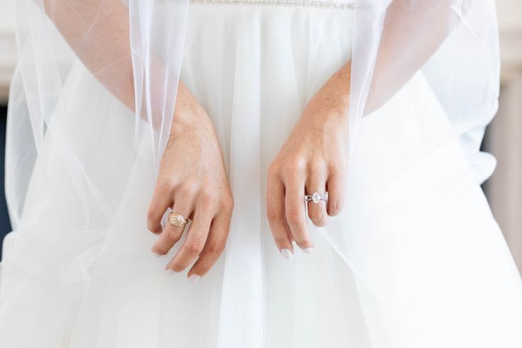 a woman in a wedding dress with her hands on her hips