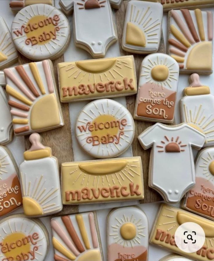 decorated cookies with welcome baby on them are arranged in the shape of sunbursts