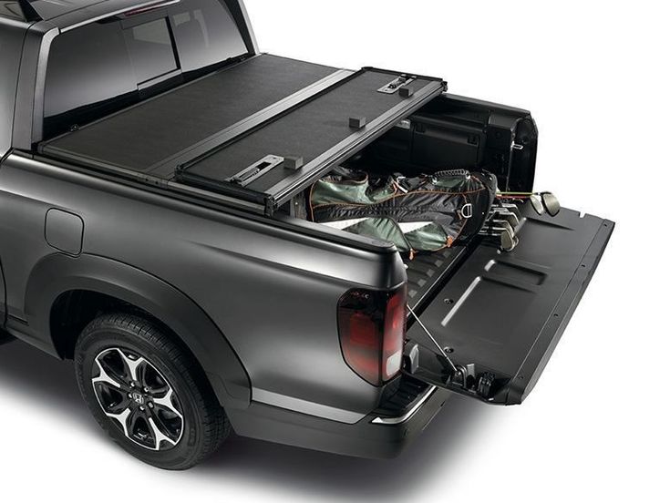 the back end of a pickup truck with its trunk open and wires attached to it