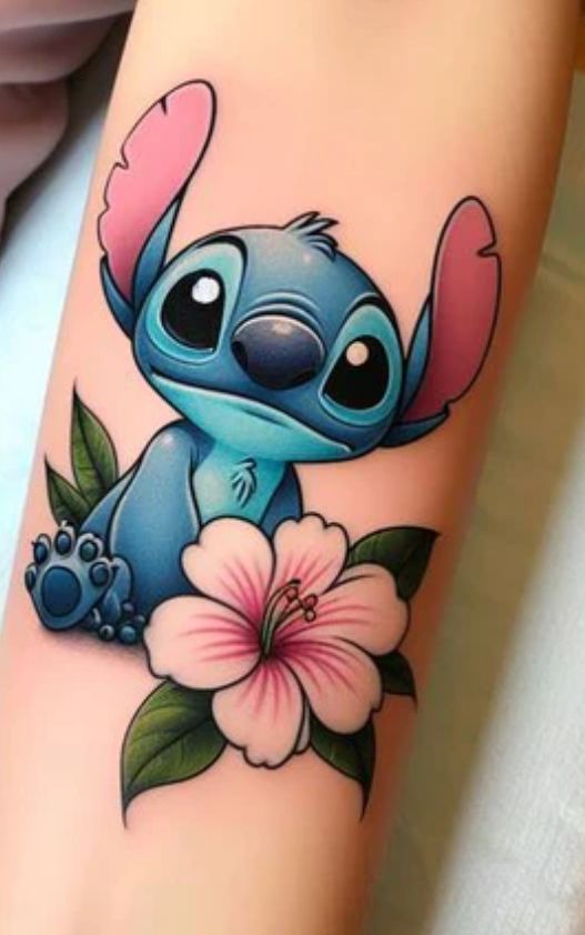 a tattoo with a cartoon character on it's arm and flowers in the foreground