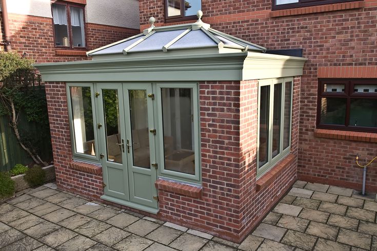 a small brick building with a glass roof