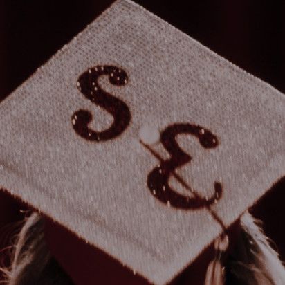 a graduate's cap with the letter s on it and a tassel hanging from it