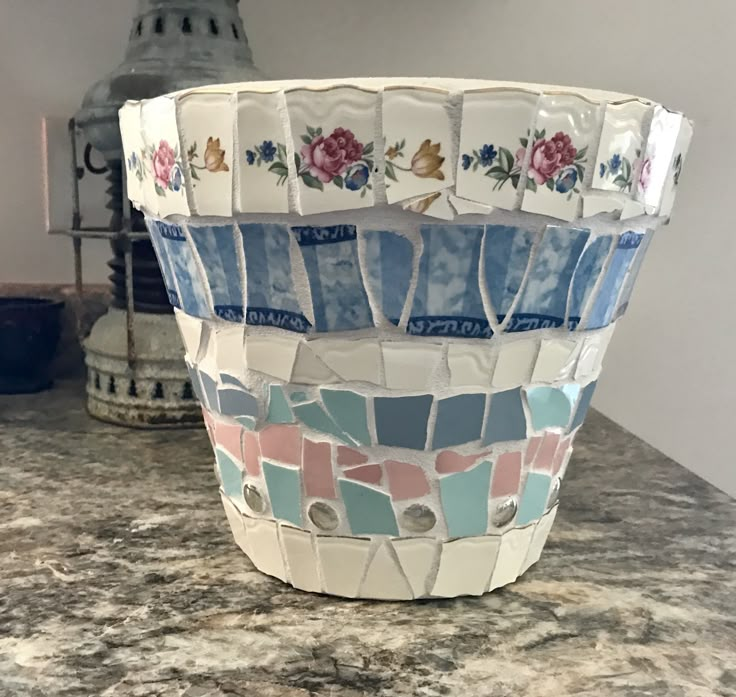 a mosaic vase sitting on top of a counter