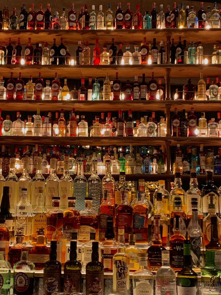 many bottles are lined up on the shelves