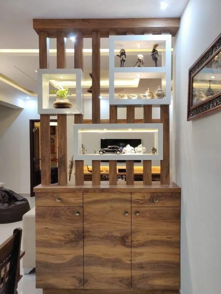 a wooden cabinet sitting in the middle of a room