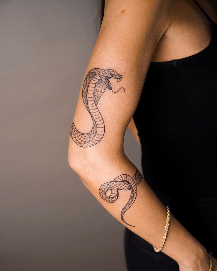 a woman's arm with a tattoo on it and an image of a snake