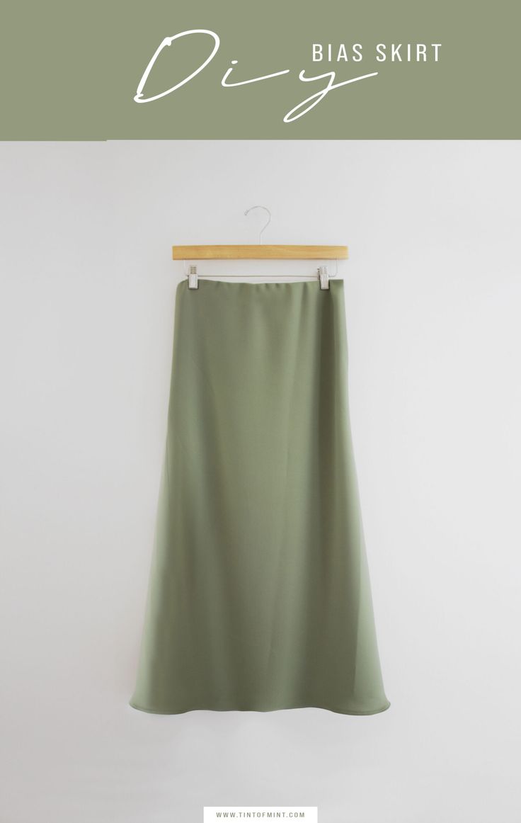 a green skirt hanging on a hanger with the words diy bliss shirt above it