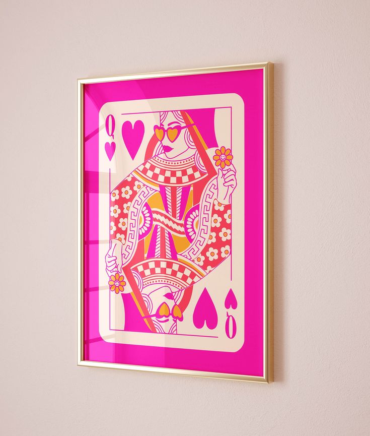 a pink and gold playing card mounted on a wall